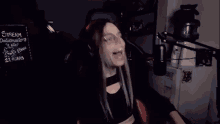 a woman is sitting in a chair in front of a microphone in a room .