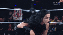 a woman in a wrestling ring holds a sign that says ' los angeles ' on it