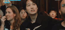 a group of people are sitting in a room with the words kbs on the bottom