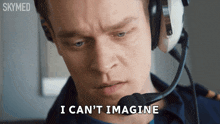a man wearing headphones and a microphone says i can t imagine