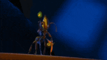a cartoon ant is holding a green bug in its mouth