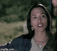 a woman wearing a necklace with a star on it