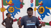 a man wearing a t-shirt that says college should n't be a