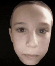 a close up of a child 's face on a black background with a blurred background .