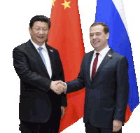 a man in a suit shakes hands with a man in a tie
