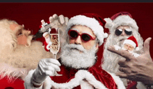 a group of santa clauses wearing sunglasses and holding glasses of champagne