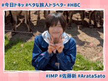a picture of a person giving a peace sign in front of some horses
