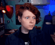 a woman with red hair is wearing a black shirt that says twice