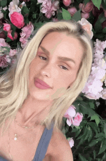 a woman with blonde hair is laying in a field of flowers
