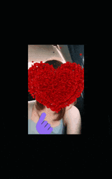 a girl with a bunch of red petals coming out of her mouth