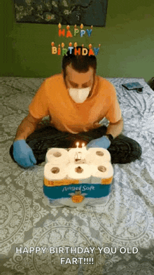 a man wearing a mask and gloves is celebrating his birthday with toilet paper and candles .