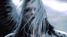 a close up of a person 's face with their hair blowing