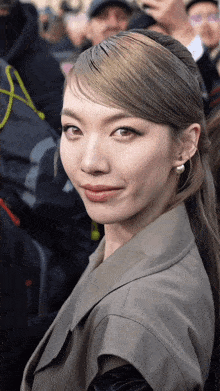 a woman with a ponytail looks at the camera