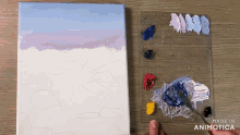a painting is being painted on a canvas next to a palette of paints made in animotica