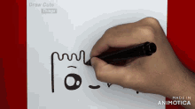 a person is drawing a face on a piece of paper