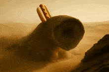 a hot dog with mustard on it is being eaten by a worm