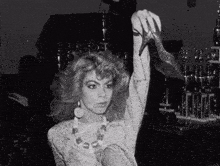 a woman in a white dress is holding a high heeled shoe in her hand