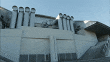 a building with a lot of pipes on it and stairs