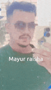 a man wearing sunglasses is taking a selfie with the name mayur raisha written on the bottom