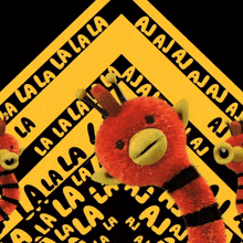 a stuffed animal is surrounded by a yellow sign that says la la la la
