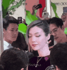 a woman taking a picture of herself in front of a jimmy choo sign
