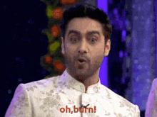 a man wearing a white suit says oh burn