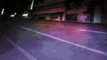 a pixelated image of an empty street at night with a building that says ' a ' on it