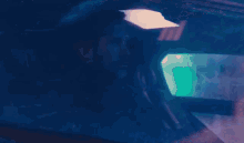 a man and a woman are sitting in a car looking out the window at each other .