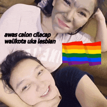 a woman with a mask on her face is laying next to another woman with a rainbow flag in the background