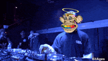 a man wearing a monkey mask is playing music on a pioneer turntable