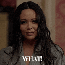 a woman in a bathrobe says " what " in front of her face