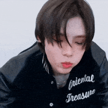 a close up of a person wearing a jacket that says oriental treasure on it