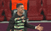a man in a striped shirt with the number 58 on the back