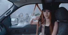 a woman is sitting in the back seat of a car
