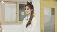 a girl in a plaid sweater is sitting at a desk in a classroom with other students .