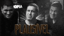 a black and white photo of three men with the word plausivel in gold
