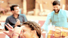 a woman is making a funny face in front of a group of people