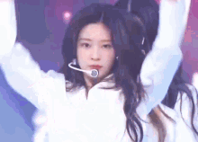 a close up of a woman wearing a microphone and headphones .