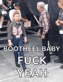 a young boy in a cowboy outfit says bootheel baby fuck yeah on the bottom