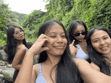 a group of young women are posing for a picture and one of them is wearing sunglasses