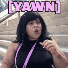 a woman wearing a lanyard with the word yawn written on it