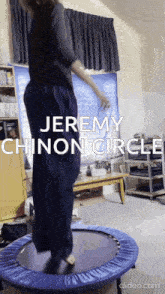jeremy chinon circle is jumping on a trampoline in a room