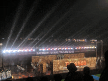 a stage with a sign that says the tale of tygkoba on it