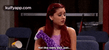 a woman is sitting in a chair holding a stuffed giraffe and saying `` not like really bad , just ... ''