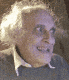 a close up of a person 's face with a blurred background .