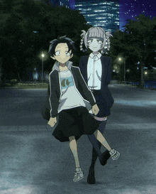 a boy and a girl are standing next to each other in a park