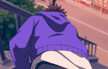 a person wearing a purple hoodie is walking down stairs