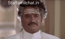 a man with a mustache and a headband has the website starttamilchat.in written on the bottom