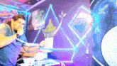 a man smoking a hookah in a room with a triangle on the wall