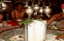Pouring Milk On Shiva Lingam Gifkaro GIF - Pouring Milk On Shiva Lingam Gifkaro Doing A Ritual GIFs